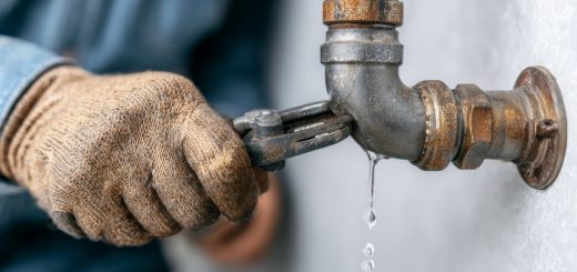 close-up of a man fixing a leaking pipe